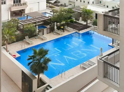 an overhead view of a large swimming pool in a building at Brand New 1BR Near Metro at Avenue Residence in Dubai