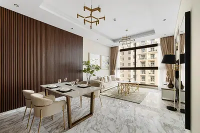 a living room with a dining table and chairs at Brand New 1BR Near Metro at Avenue Residence in Dubai