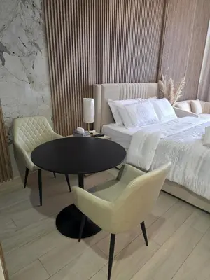 a bedroom with a table and chairs and a bed at Luxury Studio With Burj Khalifa Views in Dubai