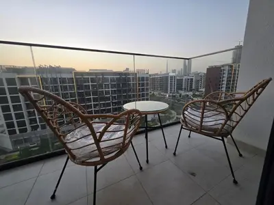 two chairs and a table on a balcony with a view at Luxury Studio With Burj Khalifa Views in Dubai