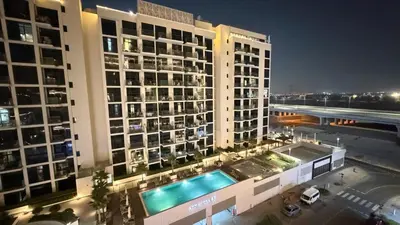 an overhead view of a building with a swimming pool at Luxury Studio with Pool Views in Dubai