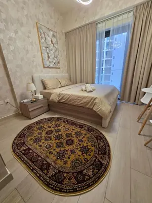 a bedroom with a bed and a rug on the floor at Luxury Studio with Pool Views in Dubai