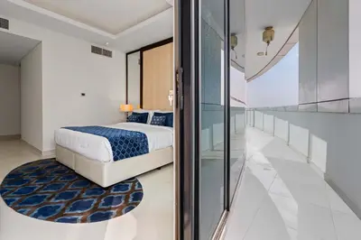 a bedroom with a bed and a glass wall at Elegant 2BR Downtown Apartment - Near Burj Khalifa in Dubai