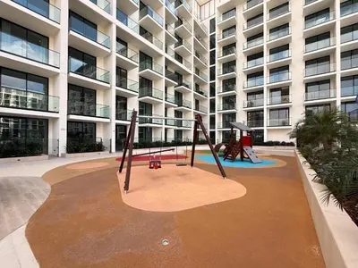 a playground in front of a large apartment building at GuestReady - Spacious 1 bedroom apartment in Dubai