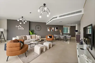 a living room with a couch and chairs and a table at Silkhaus Expansive 2BDR in Sky Gardens DIFC in Dubai