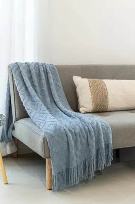 a blanket on a couch in a living room at Airstay - Full Marina Views - Coastal Studio - Monthly Offer Available! in Dubai