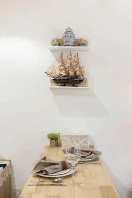 a dining room with a wooden table with a model ship on a shelf at Airstay - Full Marina Views - Coastal Studio - Monthly Offer Available! in Dubai