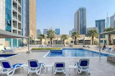 a pool with chaise lounge chairs and a pool at Airstay - Full Marina Views - Coastal Studio - Monthly Offer Available! in Dubai