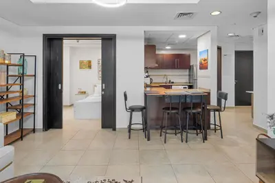 a kitchen with a table and chairs in a room at Modern 2BR Apartment - City Views - Goldcrest Views 2 in Dubai