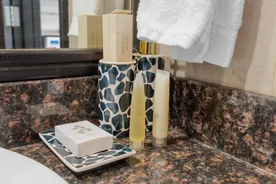 a bathroom with two vases and a box on a counter at Modern 2BR Apartment - City Views - Goldcrest Views 2 in Dubai