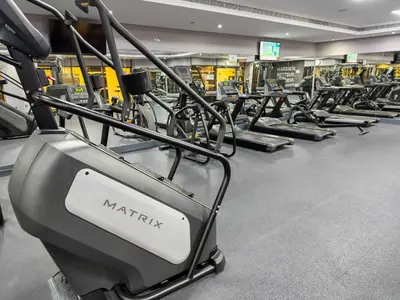 a gym with many rows of cardio machines at Modern 2BR Apartment - City Views - Goldcrest Views 2 in Dubai