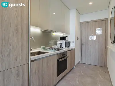 a kitchen with a sink and a microwave at HiGuests - Dubai Skyline Studio with Premier Views in Dubai