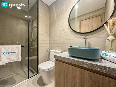 a bathroom with a sink and a toilet and a mirror at HiGuests - Dubai Skyline Studio with Premier Views in Dubai