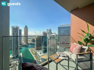 a balcony with a chair and a view of the city at HiGuests - Dubai Skyline Studio with Premier Views in Dubai