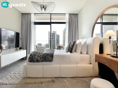 a bedroom with a white bed and a large window at HiGuests - Dubai Skyline Studio with Premier Views in Dubai