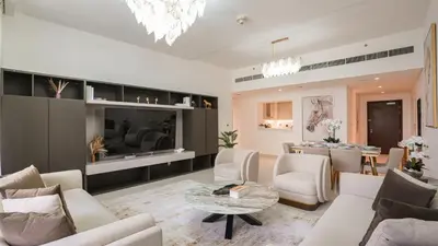 a living room with a couch and a table at Deluxe Pool View apartment in BLVD Crescent Downtown Dubai by Norbu Holiday Homes in Dubai