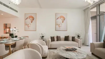 a living room with a table and chairs at Deluxe Pool View apartment in BLVD Crescent Downtown Dubai by Norbu Holiday Homes in Dubai