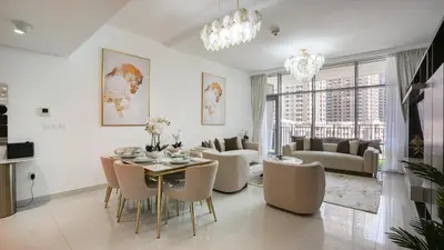 a living room with a table and chairs at Deluxe Pool View apartment in BLVD Crescent Downtown Dubai by Norbu Holiday Homes in Dubai