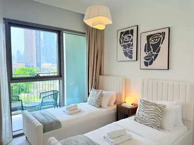 a hotel room with two beds and a window at Luxury Burj Khalifa View Downtown Residence at Burj Vista Apartment in Dubai