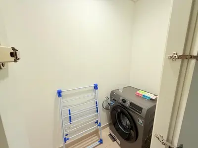 a washing machine in a laundry room with a washer at Luxury Burj Khalifa View Downtown Residence at Burj Vista Apartment in Dubai