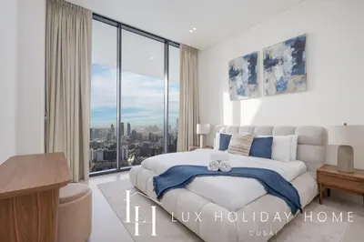 a bedroom with a bed and a large window at LUX The Phantom Sky Pool Suite in Dubai