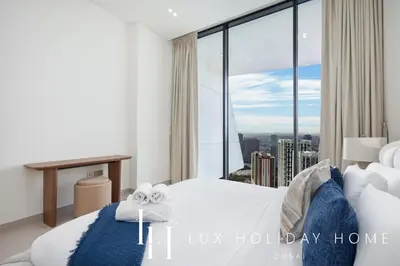 a bedroom with a bed and a large window at LUX The Phantom Sky Pool Suite in Dubai