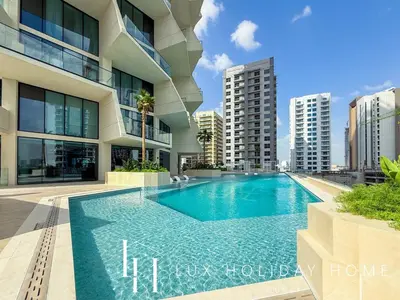 a swimming pool in front of a building at LUX The Phantom Sky Pool Suite in Dubai