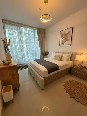 a bedroom with a large bed and a large window at Bluebell reidence jvc in Dubai