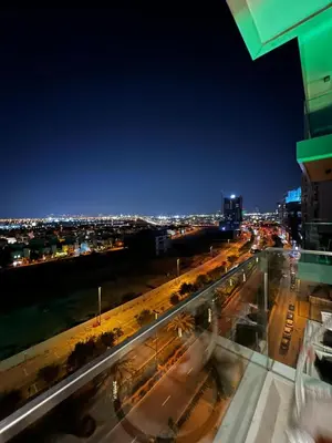a view of a city at night with lights at Bluebell reidence jvc in Dubai