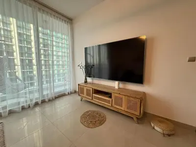 a living room with a flat screen tv on a wall at Bluebell reidence jvc in Dubai