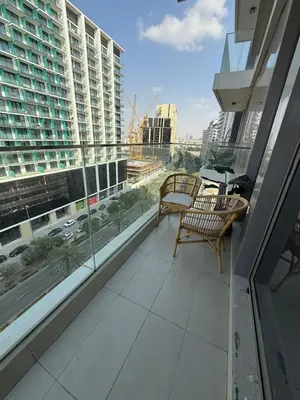 a balcony with chairs and a view of a building at Bluebell reidence jvc in Dubai