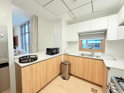 a kitchen with a sink and a microwave at Luxury Apartments in Burj Vista Dubai With Burj Khalifa View Near Dubai Mall in Dubai