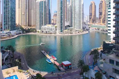 a river with a boat in the middle of a city at Bright 2BR in Dubai Marina - Close to beach in Dubai