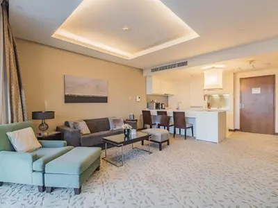 a living room with a couch and a table at Direct Dubai Mall Access-Emaar Residences-1BR Like Home in Dubai