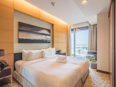 a hotel room with a large bed and a large window at Direct Dubai Mall Access-Emaar Residences-1BR Like Home in Dubai