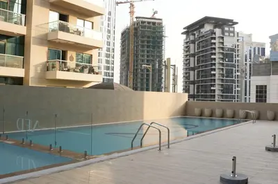a swimming pool on top of a building with tall buildings at Luxury Brand New 2 BR Apartment Burj & Canal View Business Bay Dubai in Dubai