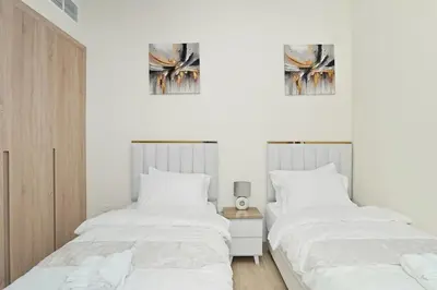 two beds sitting next to each other in a bedroom at Luxury Brand New 2 BR Apartment Burj & Canal View Business Bay Dubai in Dubai