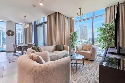 a living room with two couches and a dining room at Burj Vista Luxury Apartments with Burj Khalifa View in Dubai