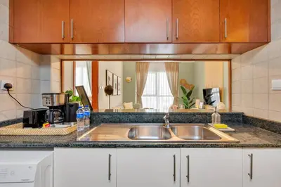 a kitchen with a sink and a counter top at JLT Cozy and Modern 1BR Pool and Gym Walk to Metro in Dubai