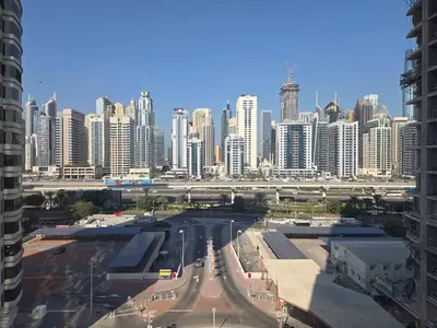 a view of a city with tall buildings and a freeway at JLT Cozy and Modern 1BR Pool and Gym Walk to Metro in Dubai