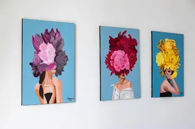 four paintings of a woman with flowers on her head at Burj Vista Modern Comfort - 1BR with Pool, Gym and Scenic views in Dubai