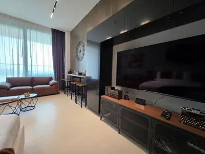 a living room with a large flat screen tv at Trillionaire Bayhouse Chic Studio - Jacuzzi with views, Pool and Gym in Dubai