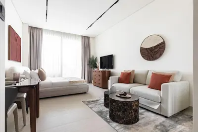 a living room with a couch and a table at The Trillionaire Bayhouse - Private Jacuzzi, Sauna, pool and gym in Dubai