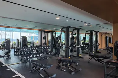 a gym with a lot of tread machines at The Trillionaire Bayhouse - Private Jacuzzi, Sauna, pool and gym in Dubai