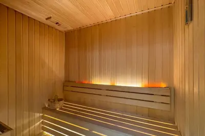 a sauna with a bench with lights in it at The Trillionaire Bayhouse - Private Jacuzzi, Sauna, pool and gym in Dubai
