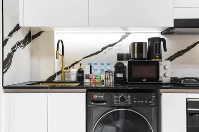 a kitchen with a microwave and a dishwasher at Trillionaire Bayhouse One- Private Jacuzzi, Sauna, pool and gym in Dubai