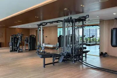 a gym with lots of treadmills and elliptical machines at Trillionaire Bayhouse One- Private Jacuzzi, Sauna, pool and gym in Dubai