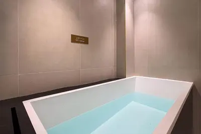 a bath tub with a blue light in a room at Trillionaire Bayhouse One- Private Jacuzzi, Sauna, pool and gym in Dubai