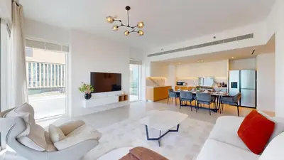a living room with a white couch and a table at Vacationer l Chic 2 Bedroom l Sea Views l Private Beach Access in Dubai