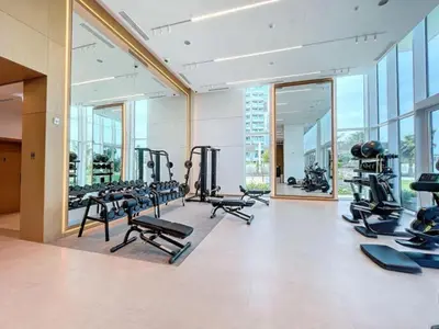 a gym with rows of treadmills and exercise bikes at Vacationer l Chic 2 Bedroom l Sea Views l Private Beach Access in Dubai